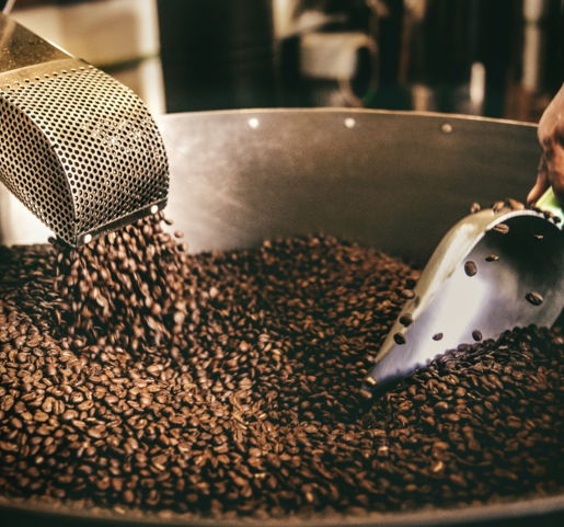 black and white ceramic fish figurine on black and brown coffee beans